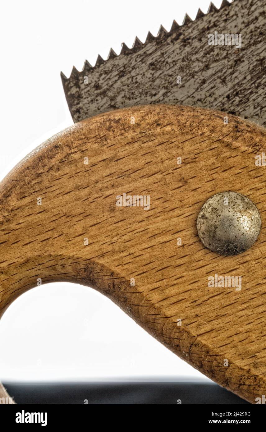 close up of wooden handle and metal toothed blade of a hand saw Stock Photo