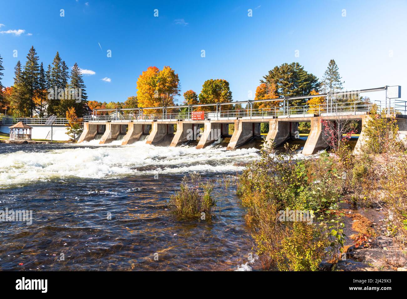 Dam on a river on a clear autumn day Stock Photo