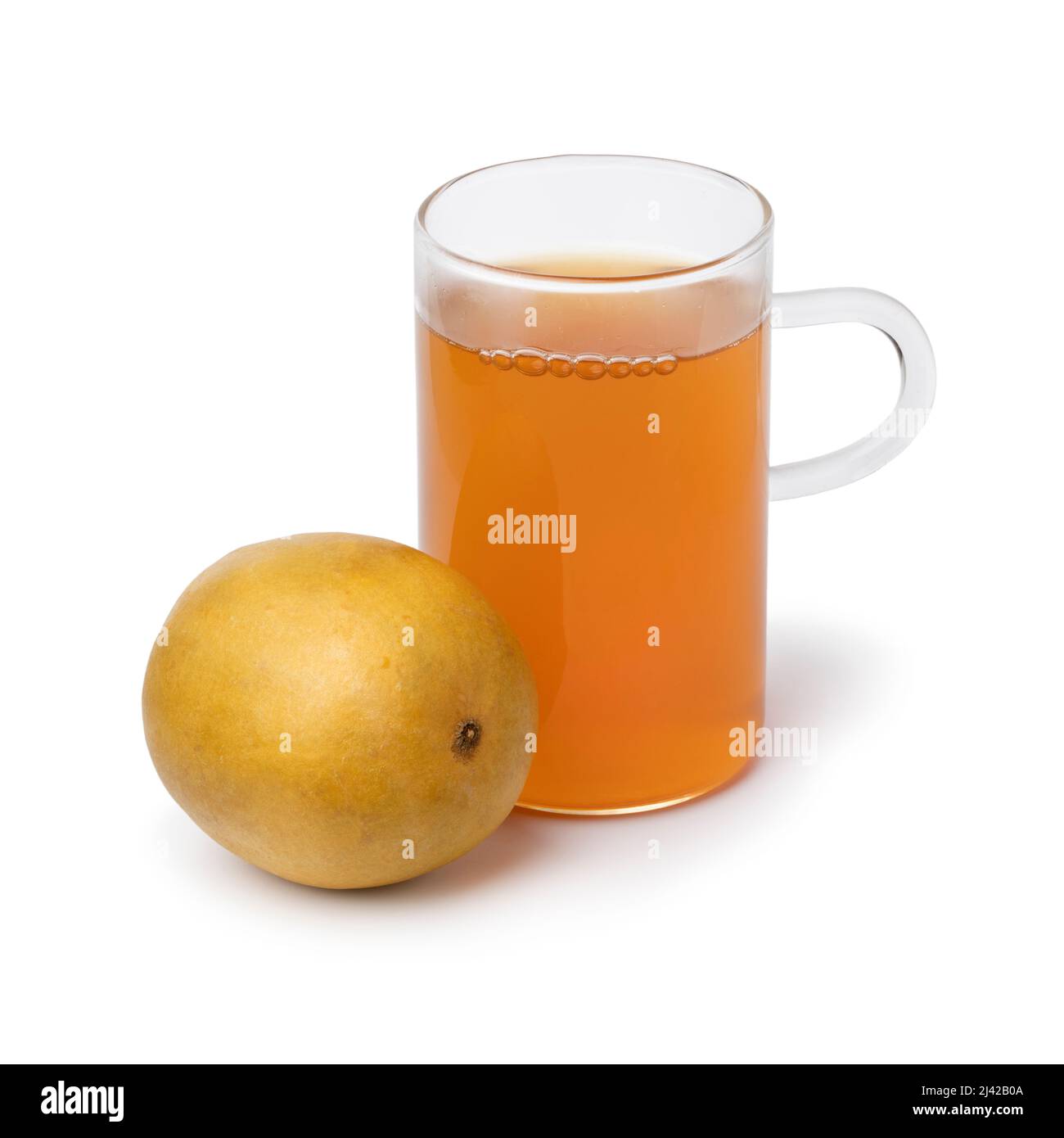 Glass of Monk fruit tea and a whole dried monk fruit, luo han guo, in front isolated on white background close up Stock Photo