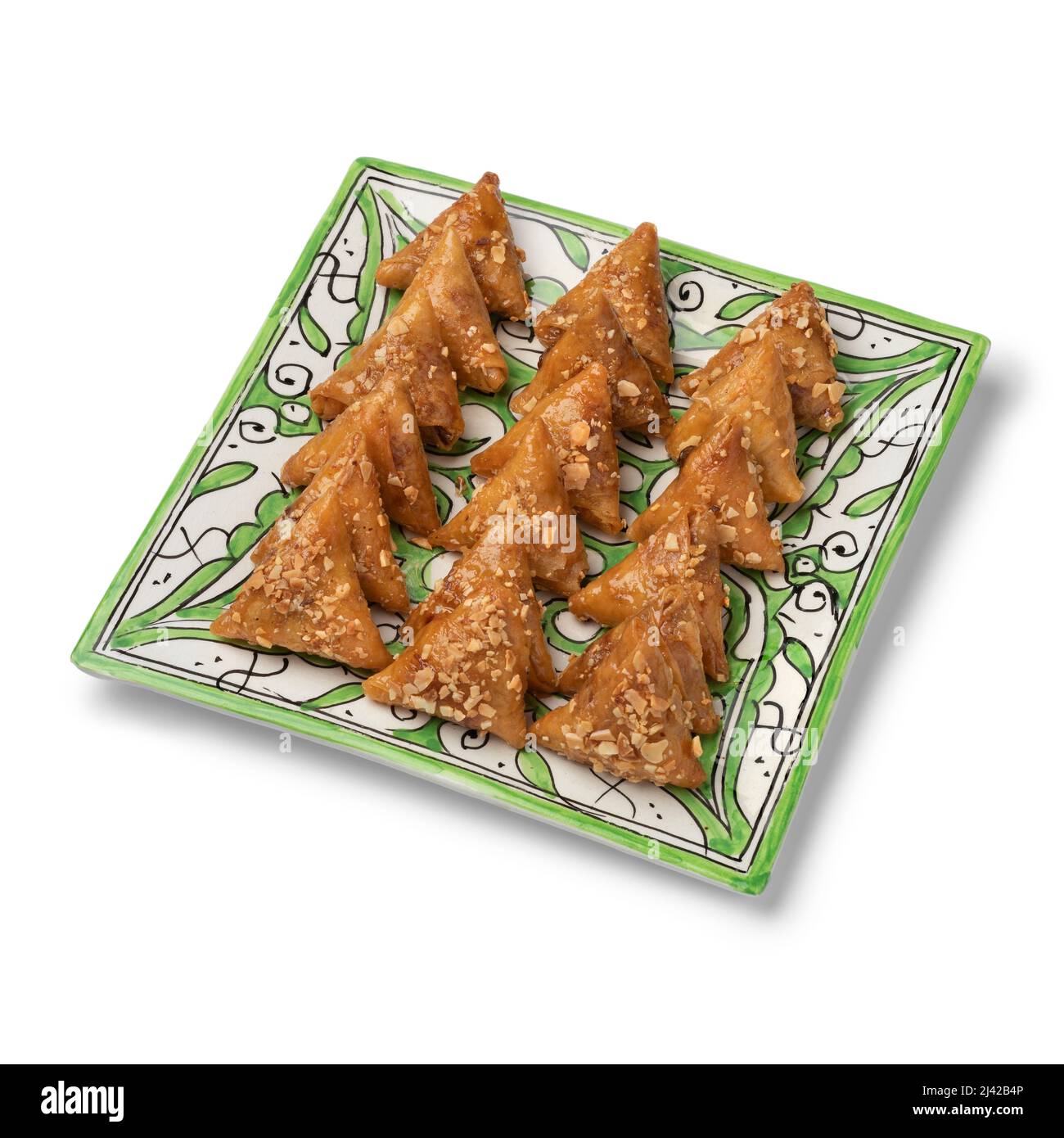 Dish with fresh traditional Almond briouats, coated in warm honey and