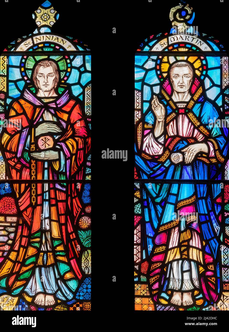 Stanley Murray Scott's (1959) depiction of two early Christian missionaries, All Saints Church, Orton, Cumbria, UK Stock Photo