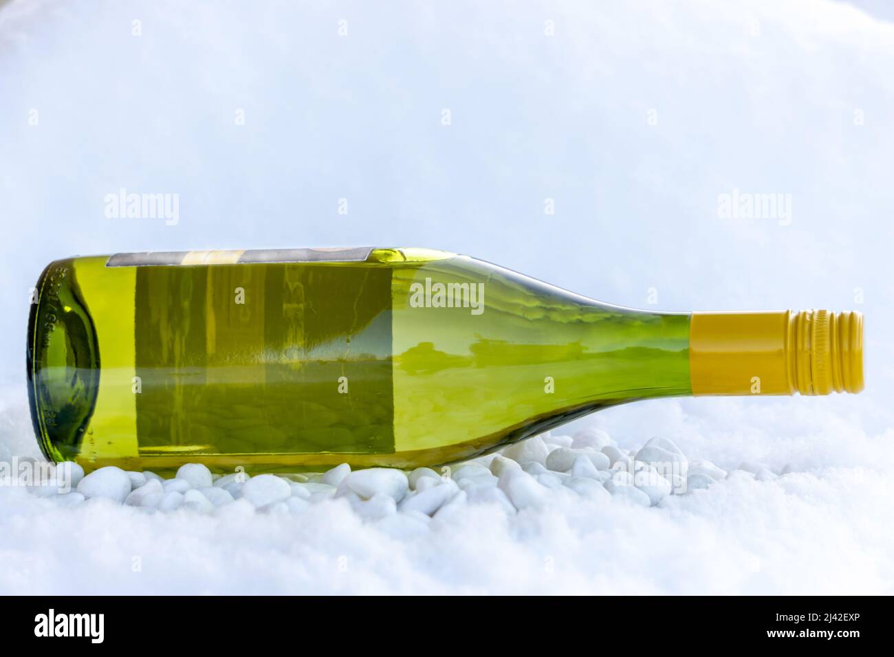 a bottle of red wine in cold snow in the middle of winter Stock Photo