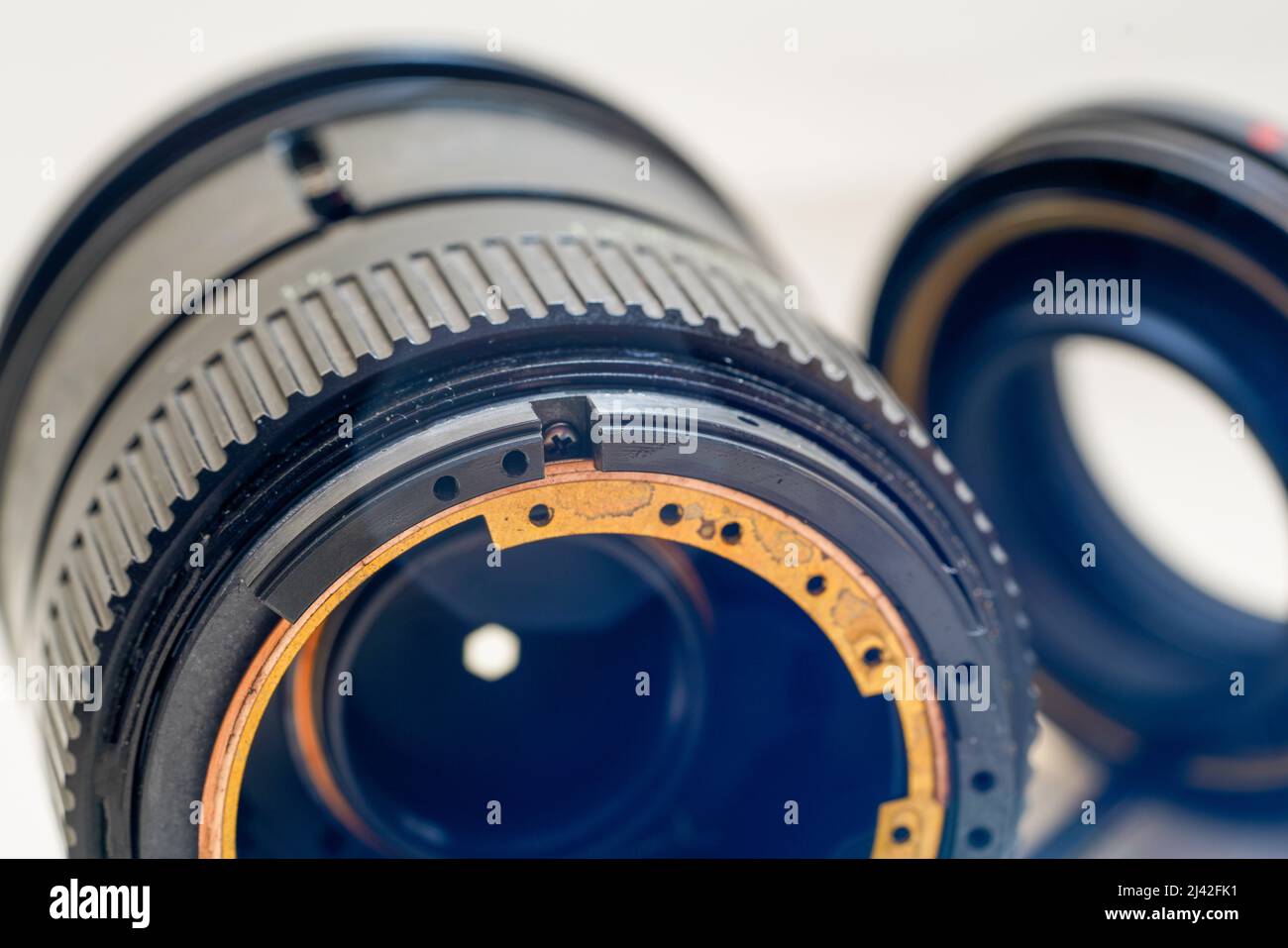 Clean and disassemble the lens for photography into its component parts ...