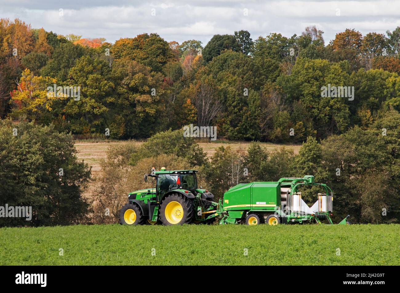 Farmer with his tractor, a John Deere, in a field Stock Photo - Alamy