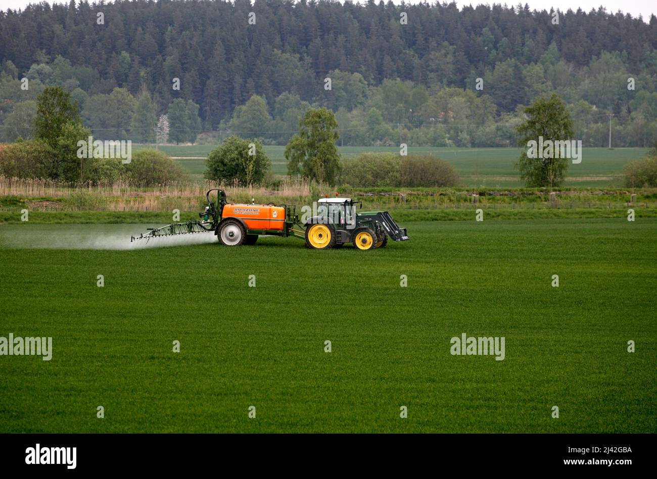 Farmers spraying their fields Stock Photo Alamy