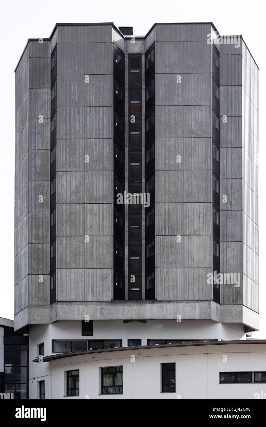 Close-up of grey rough surface concrete facade of brutalist architectural style building with symmetrical lines and building elements in Chamonix Stock Photo