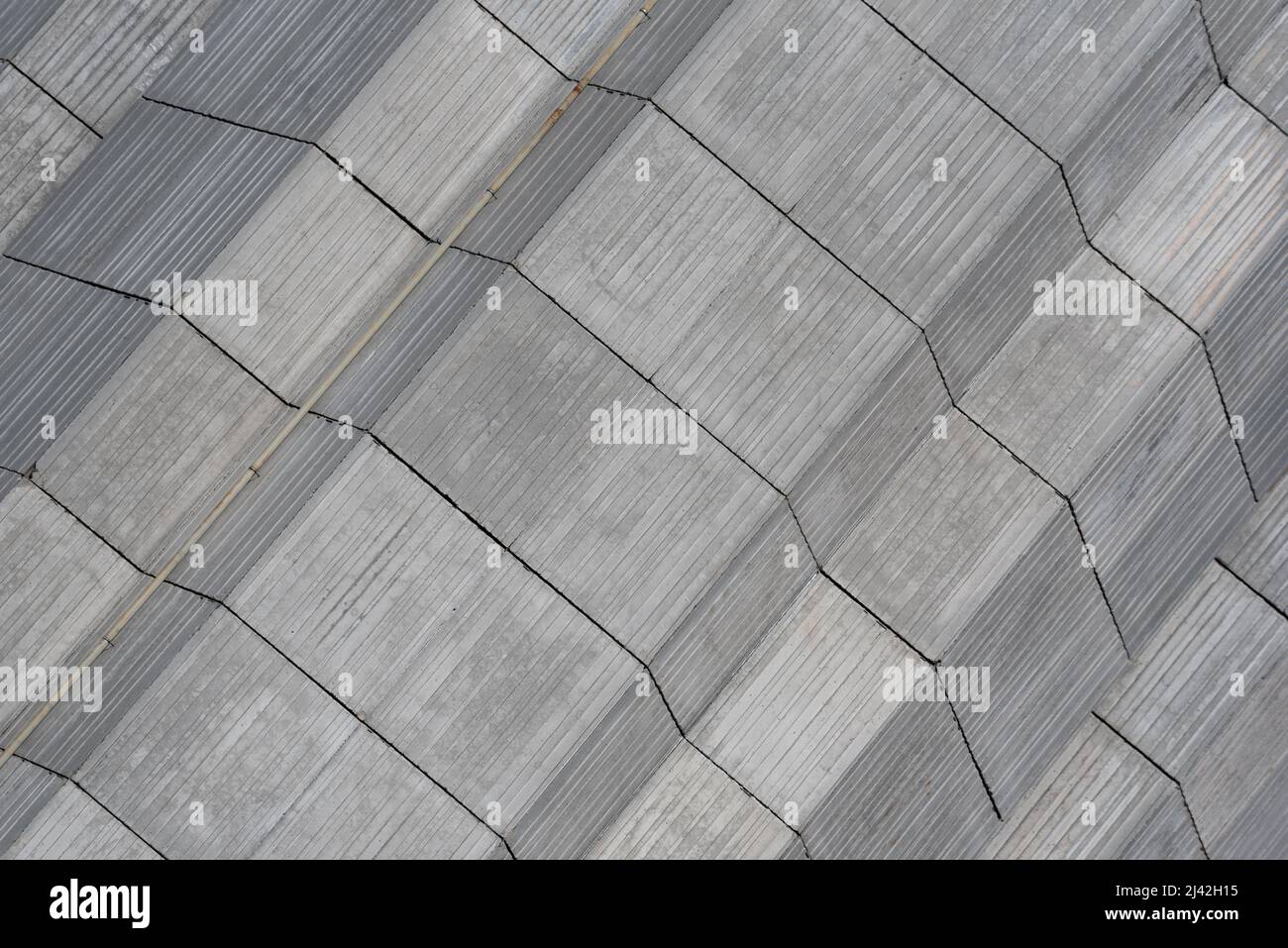Close-up of grey rough surface concrete facade of brutalist architectural style building with symmetrical lines and building elements in Chamonix Stock Photo