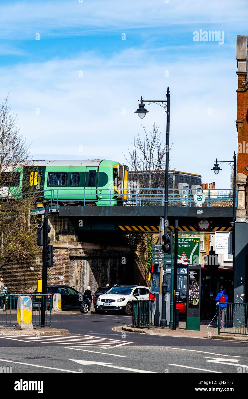 Epsom Surrey London UK, April 11 2022, Southern Rail Commuter Train Crossing A Railway Bridge With Traffic Below Stock Photo