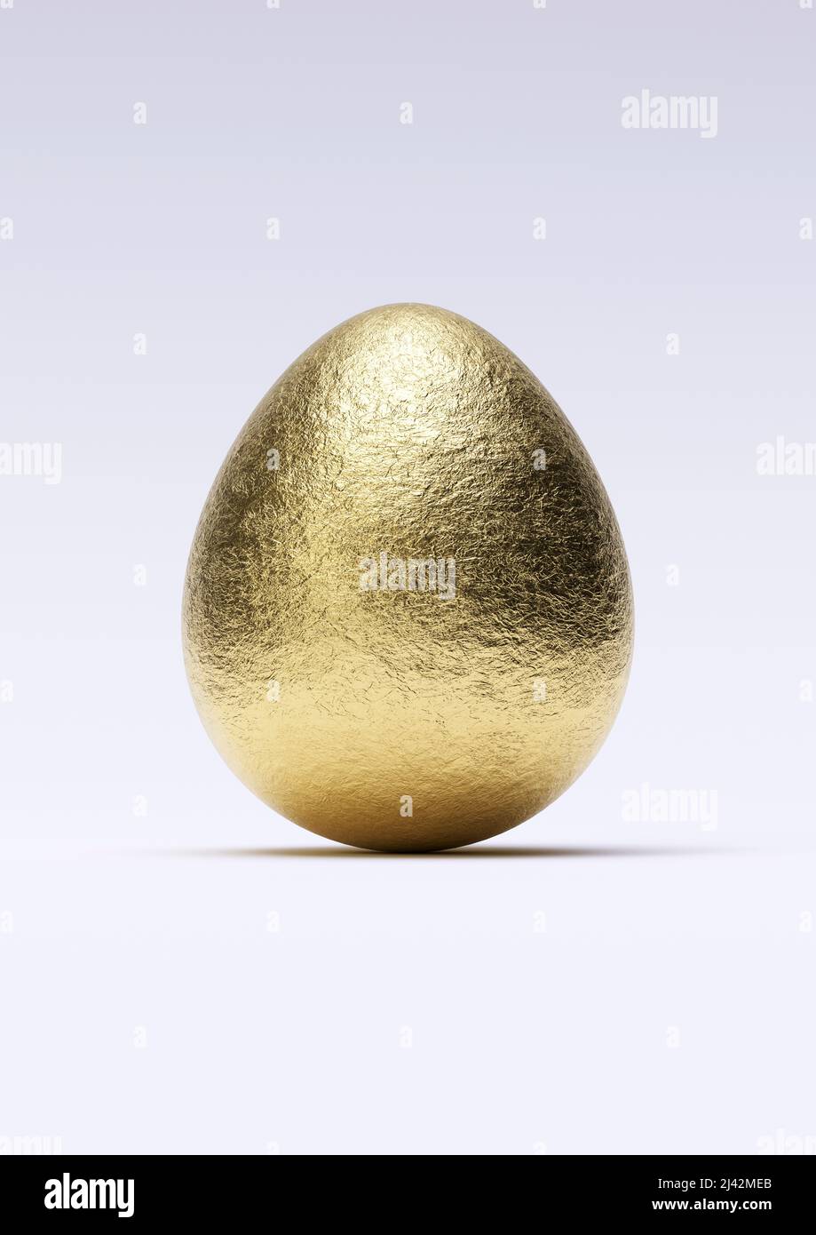 Chocolate easter egg with shiny gold foil on white background. Close-up. Stock Photo