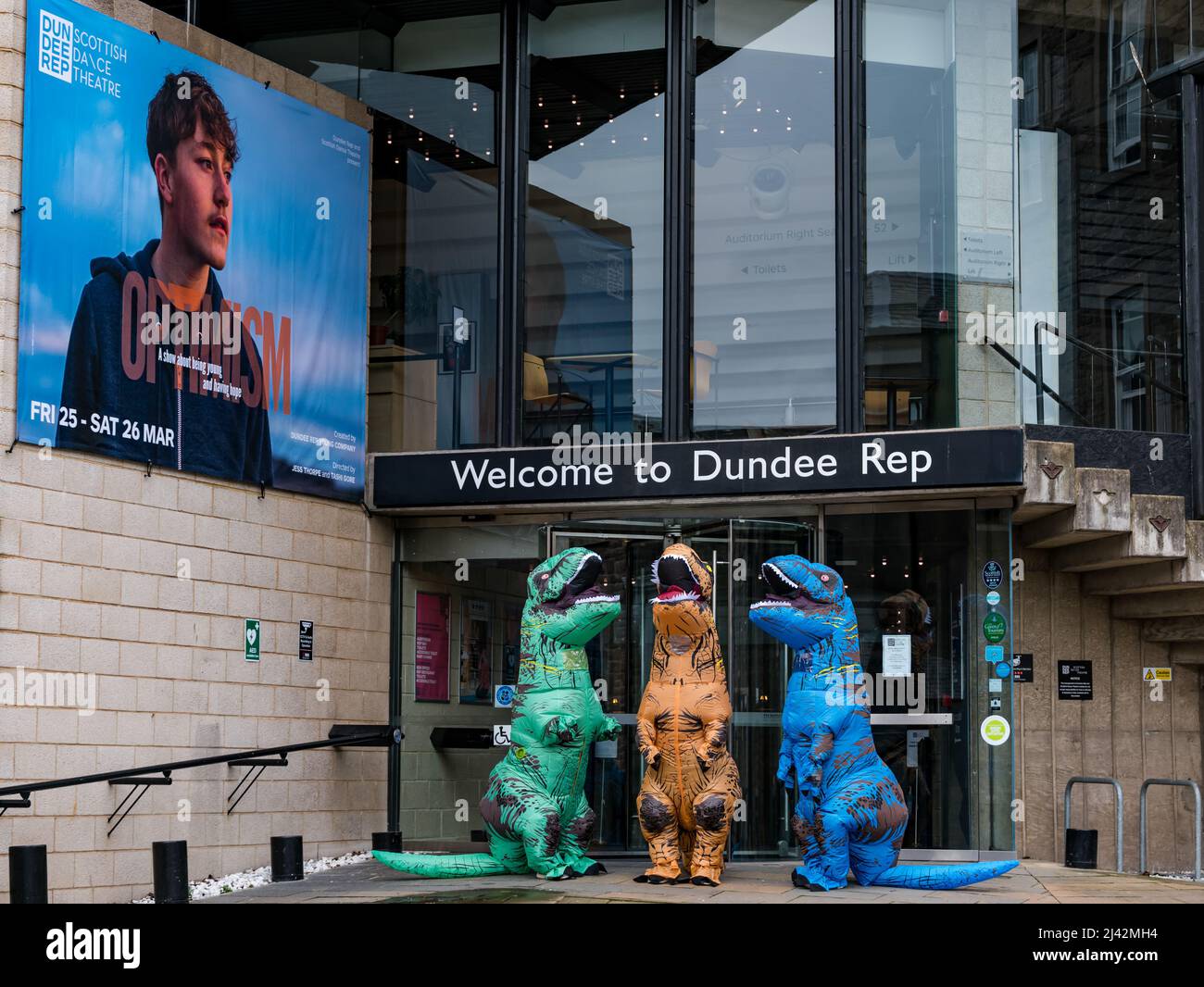 Actors dressed in quirky dinosaur costumes for launch of play Optimism outside Dundee Rep Theatre, Scotland, UK Stock Photo