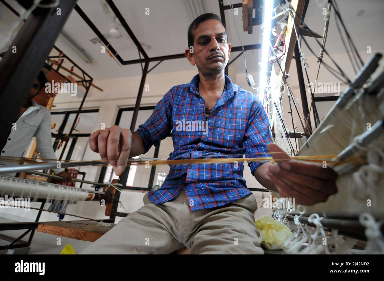 New Delhi, India. 11th Apr, 2022. Workers manufacture Chanderi Silk and Cotton Sarees by weaving in Chanderi Madhya Pradesh, near New Delhi, India on Apr. 11, 2022. Thousands of families work using traditional techniques such as pit looms and frame looms to make traditional world famous chanderi silk sarees. (Photo by Ravi Batr/Sipa USA) Credit: Sipa USA/Alamy Live News Stock Photo