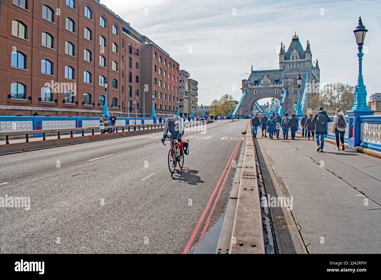 A lone cyclist riding on an empty Tower Bridge Stock Photo