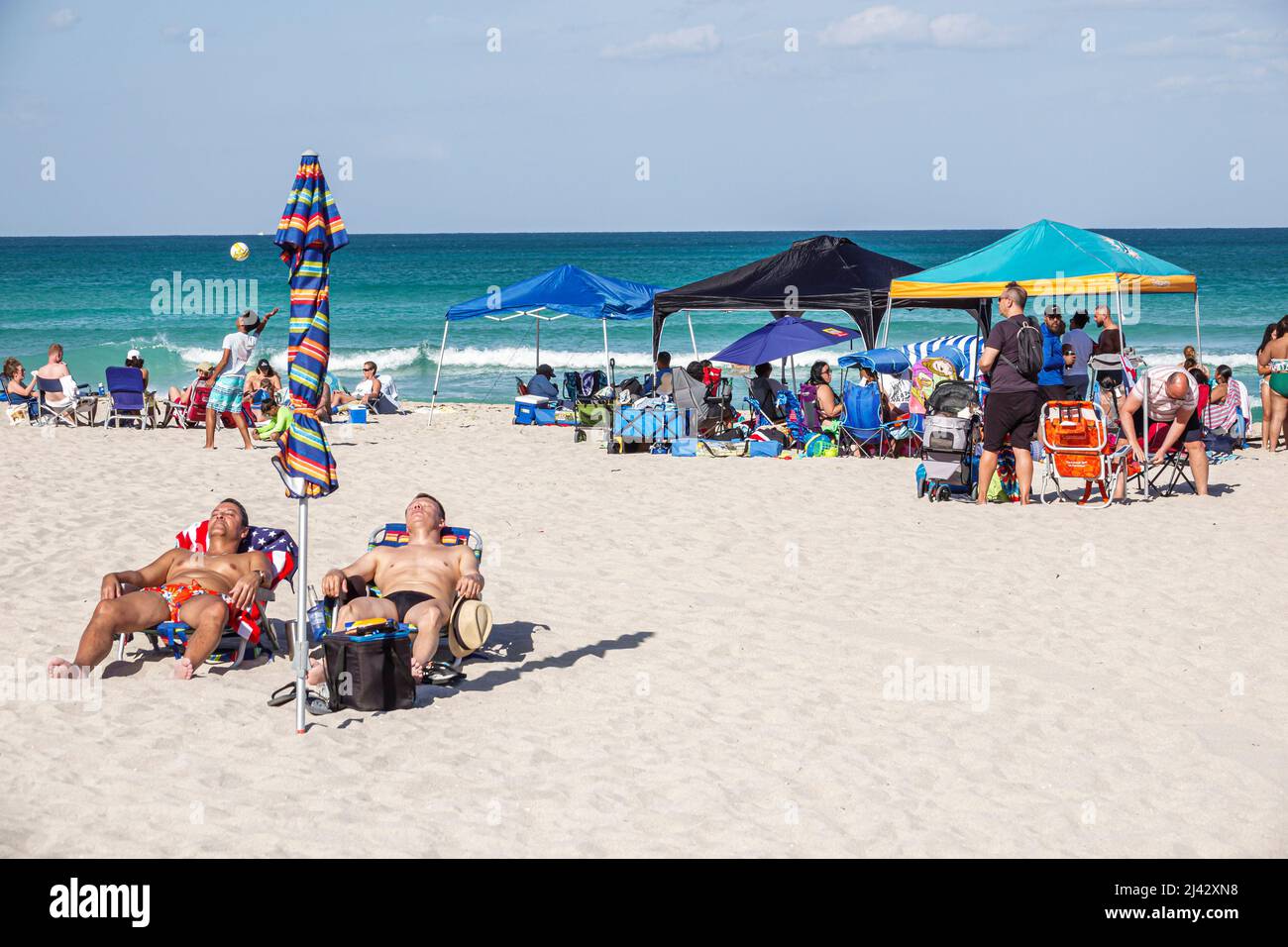 Miami Beach Florida public North Beach sunbathers Atlantic Ocean people Hispanic families Stock Photo