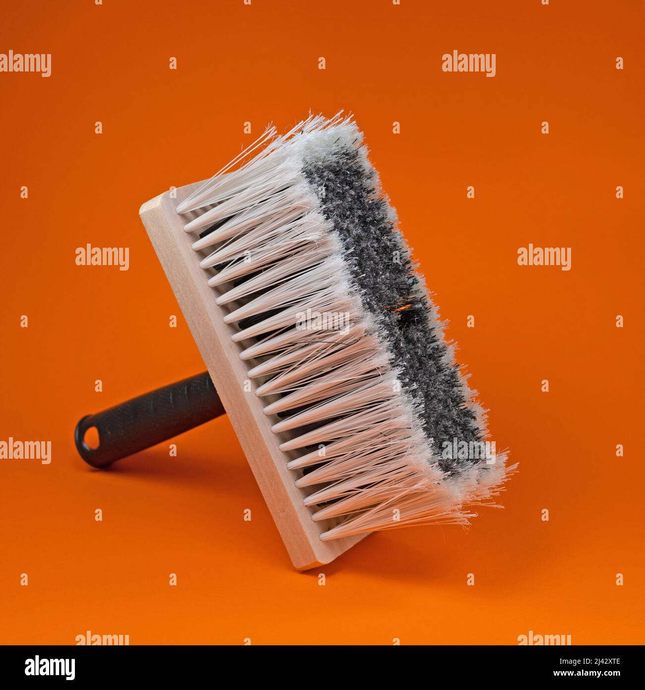 Wide brush against an orange background Stock Photo