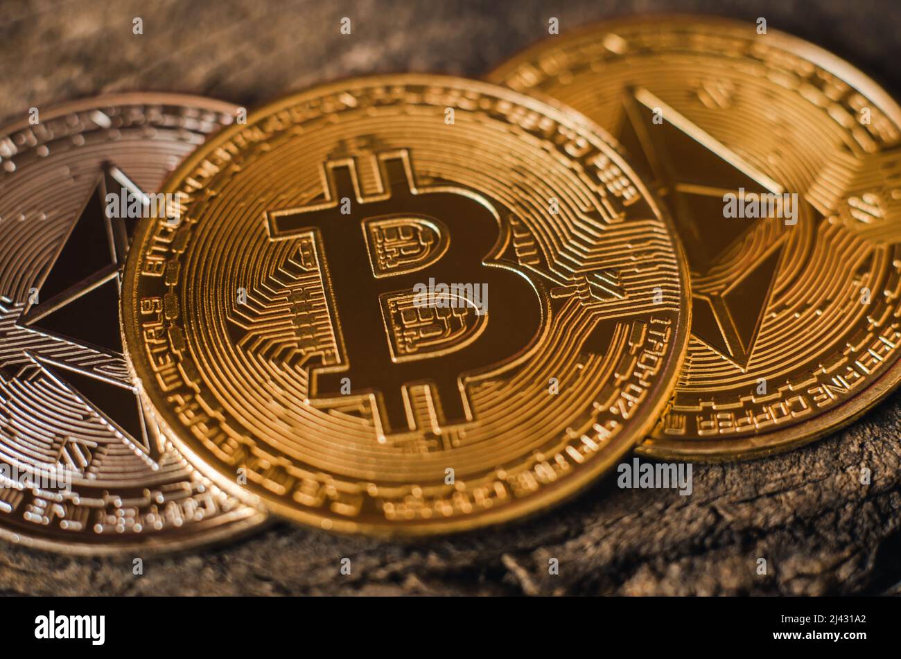 Bitcoin gold coin lies on Ethereum coins. World cryptocurrency Stock Photo - Alamy
