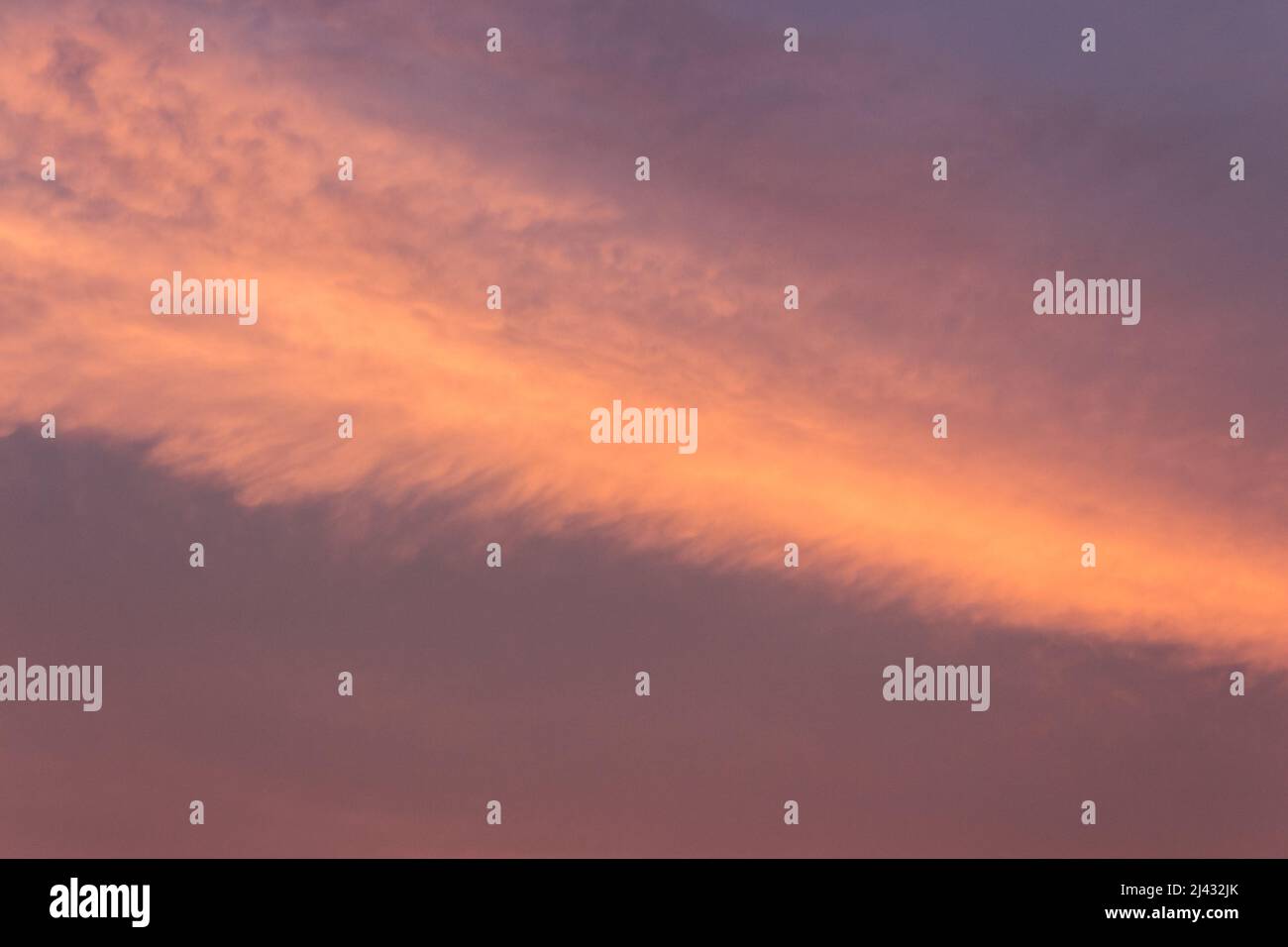 glowing clouds on the red sky in evening light. dramatic weather in summer at dusk Stock Photo