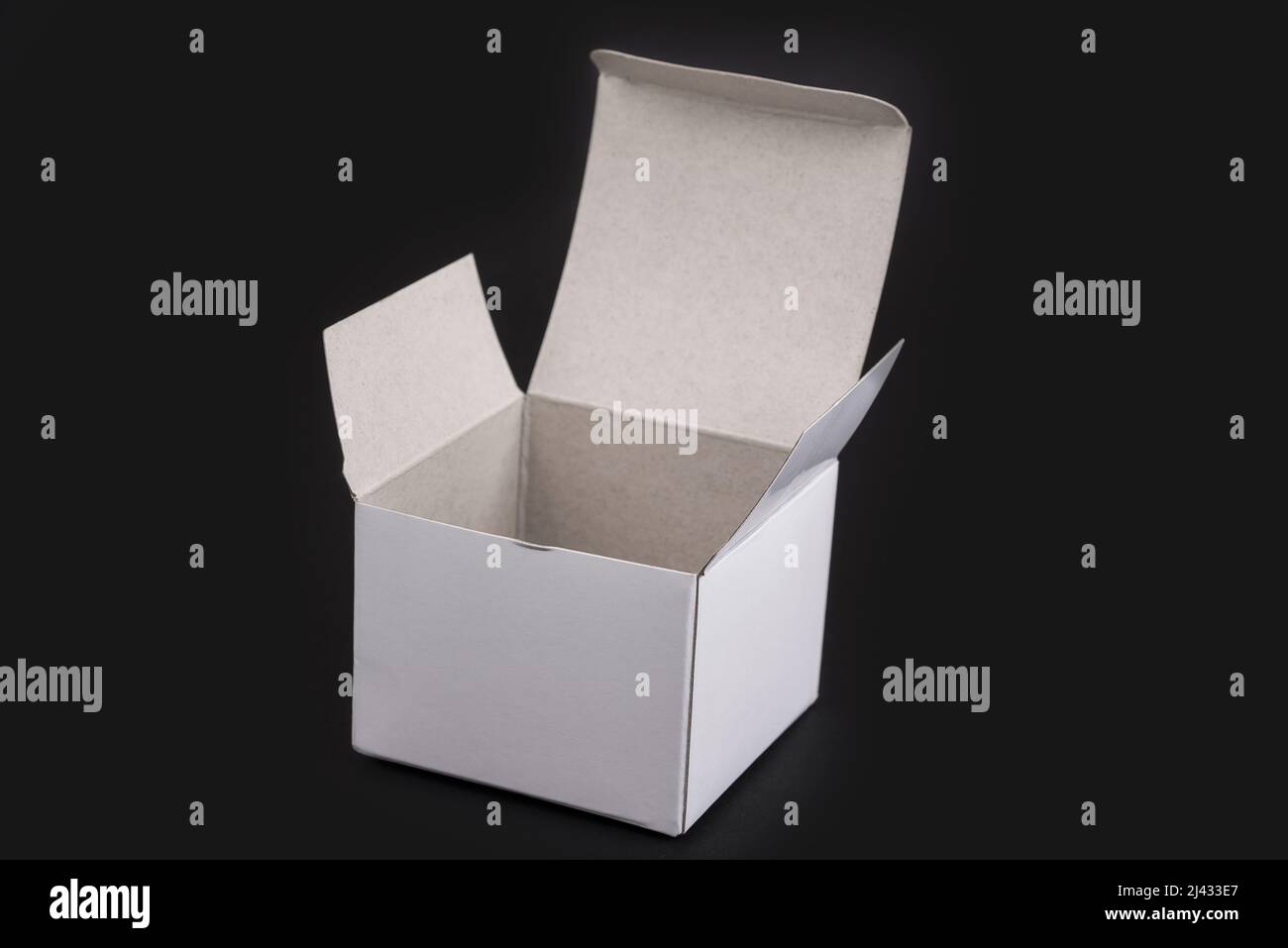 Empty white paper box on a black background Stock Photo