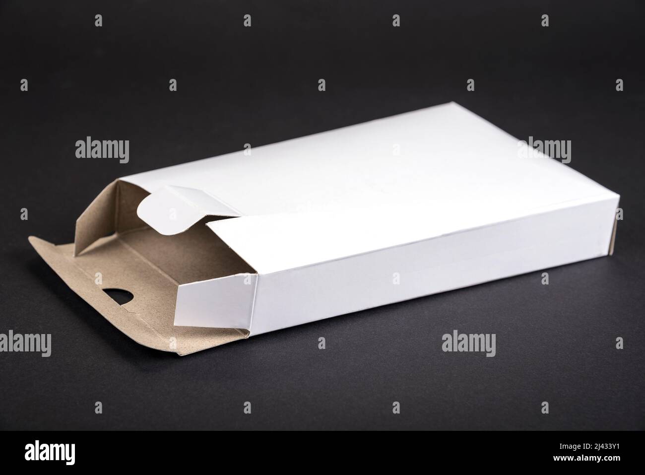 Empty white paper box on a black background Stock Photo