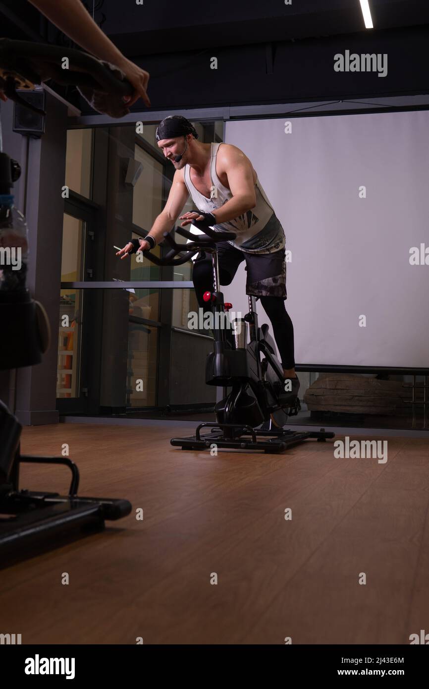Athlete on pumped bicycle up a bike trainer legs training gym fit, for ...