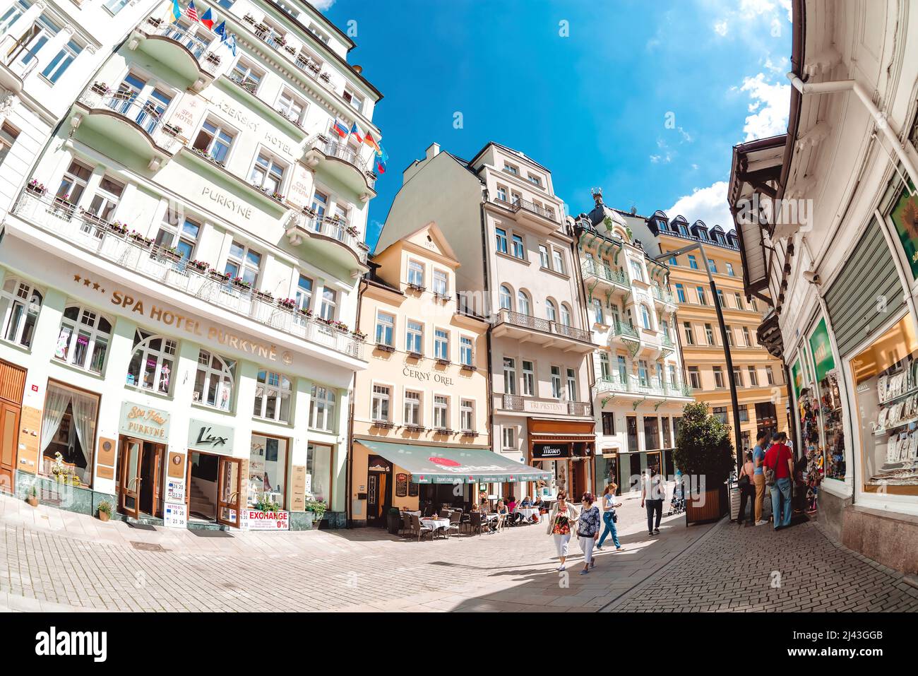 Karlovy Vary, Czech Republic - May 26, 2017: Tourists walking by pedestrian street with shops and hotel Stock Photo