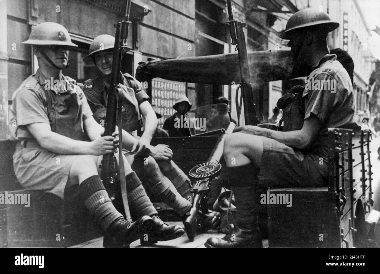 British Tommies In Shanghai Streets Again -- British Tommies with rifles and Bayonets in Shanghai street, ready for trouble should it arise. Early in May when Japanese troops Invaded the Shanghai International settlement again because of a bomb thrown on the nanking road British troops were again called to keep order. After lengthy negotiations between the Japanese and the settlement authorities, the Japanese withdrew. June 7, 1938. (Photo by Associated Press Photo). Stock Photo