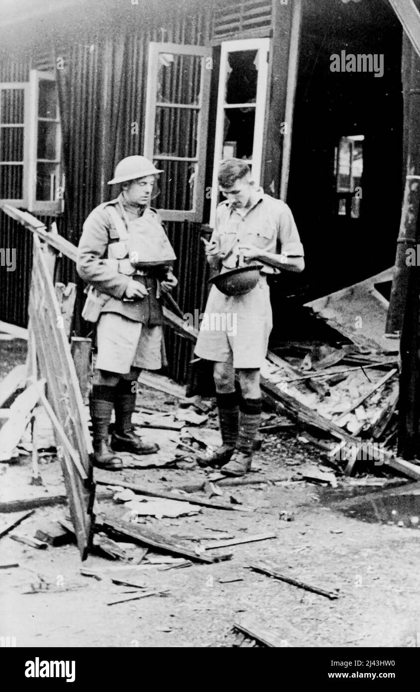 Where Four British Soldiers Perished In China -- Two Royal Ulster riflemen examining the damage after a Jap shell had burst on their Barracks West of Shanghai. Four men of the Royal Ulster rifle brigade were killed and three wounded when Japanese artillery shells struck British defence lines on the Western border of Shanghai today. November 23, 1937. (Photo by Associated Press Photo). Stock Photo