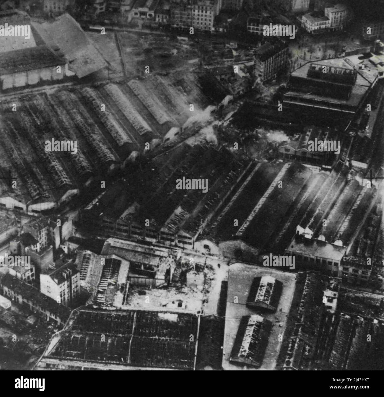 R.A.F. Bomb Paris Works After The Raid -- Aircraft of the R.A.F. flew over the works at a low altitude on the following day and secured these close-ups. The areas C1 and C2 in picture guide. In foreground is the wreck of the modelling department: in the centre destroyed workshops. Note the care taken to concentrate the attack upon the factory itself. March 03, 1942. (Photo by British Official Photograph). Stock Photo