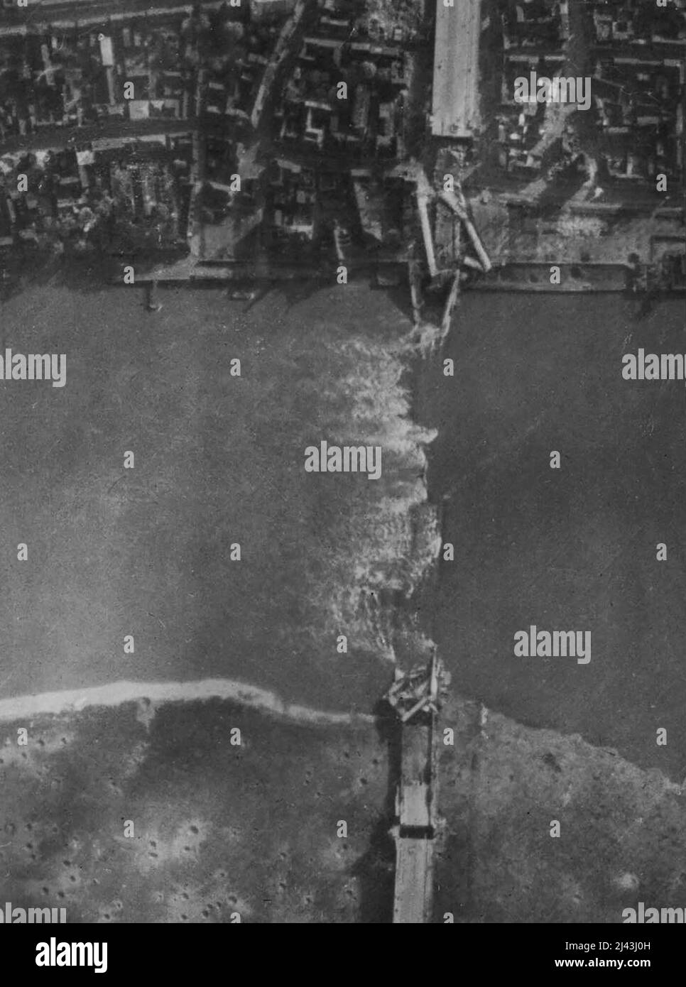 R.A.F. Attack On Cologne Of 28/10/44. Another RAF. reconnaissance picture taken after the attack of 28/10/44. Shows the large highway suspension bridge which was completely demolished. Cologne, worst damaged city in the whole of the Ruhr and Rhineland, was given its heaviest attack of the whole war by RAF. Bomber Command in the daylight attack of 28/10/44. Lancasters and Halifaxes dropped a great weight of high explosives and incendiary bombs on the railway and industrial city. The bombers were Stock Photo