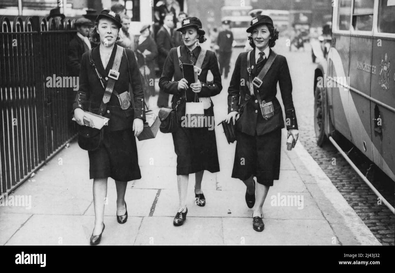 War-Time Bus Conductresses -- The first war-time omni bus conductresses have already made their appearance at Manchester. Here are three in their smart uniforms, going on duty. September 13, 1939. (Photo by Keystone). Stock Photo