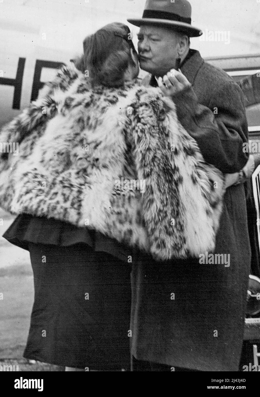A Feck From Mr. Churchill -- Mr. Churchill Fecks his daughter Mary's cheek in farewell on their arrival at Biggin Hill, as they go different ways. Mr. Winston Churchill and his family arrived back in London to-day from their holiday in Switzerland. He had flown in the bad weather from Zurich to Biggin Hill Airfield. September 20, 1946. Stock Photo