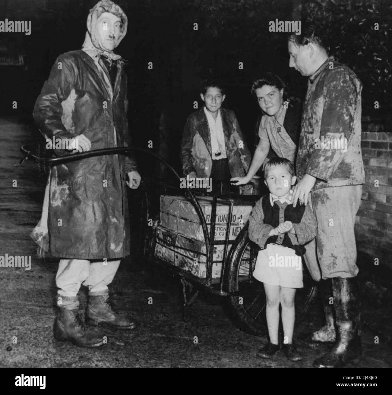 The family pictured above has just received allotment being issued by the ***** Army ***** allied and ***** objects in the international settlement of Kobe, Japan. October 01, 1945. Stock Photo
