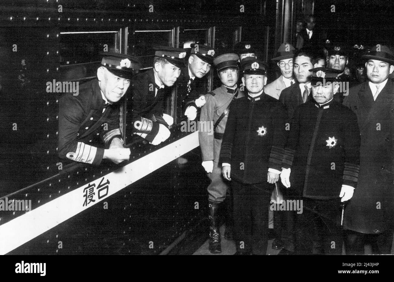 Japanese Naval Delegate to the Geneva Disarmament Conference, Vice-Admiral Shushi Nagano taken at the Tokyo Central Station when he depurated for Geneve. Picture Shows from left in train Vice-Admiral Nagano, Rear-Admiral Hasegawa, a delegate, and out of the train, standing in black uniform, form left, Admiral Keisuke Okada, Naval Minister, Admiral Kanji Okada, one of the biggest leaders of the Navy. December 5, 1932. Stock Photo