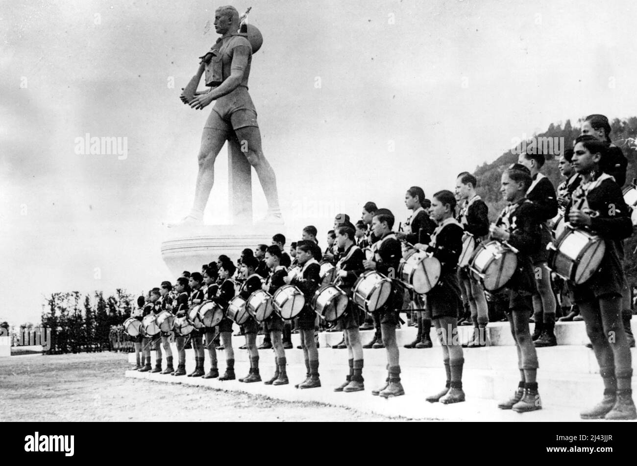 Mussolini Opens New Ballila Academy of Music Young Drummers of the new academy, lined up at the memorial, during the ceremony in Rome. On the occasion of the opening of the new Music Academy for Young Fascistal Signor Mussolini unveiled a huge statue of a Ballila (Young Fascist), carrying rifle and gas mask. April 07, 1936. (Photo by Keystone) Stock Photo