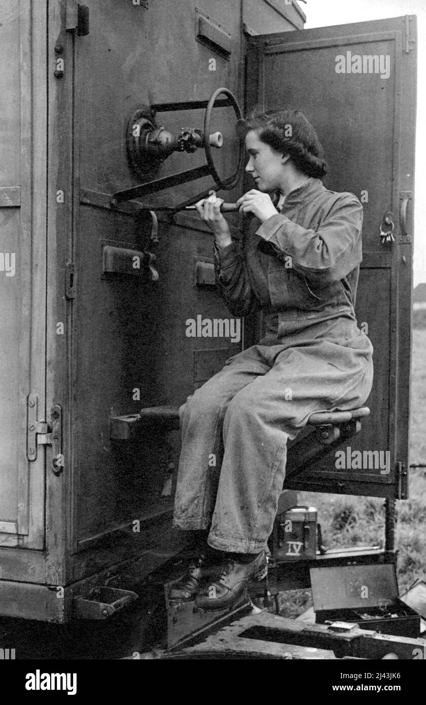 A.T.S. Maintain Radio location - Craftswomen Doris Birt, aged 21, of Brixton London S.W., is a radio mechanic at an 4.4 command radio workshops. A clerk in an insurance company in the city before the war. She is now a highly skilled expert in repairing radio location environment. Here she is overhauling part of a radio location receiver. August 16, 1943. (Photo by London News Agency Photos). Stock Photo