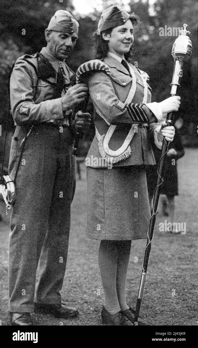 The Drum Major Must Be Correct Band master A.O. Nash makes a final adjustment to the uniform