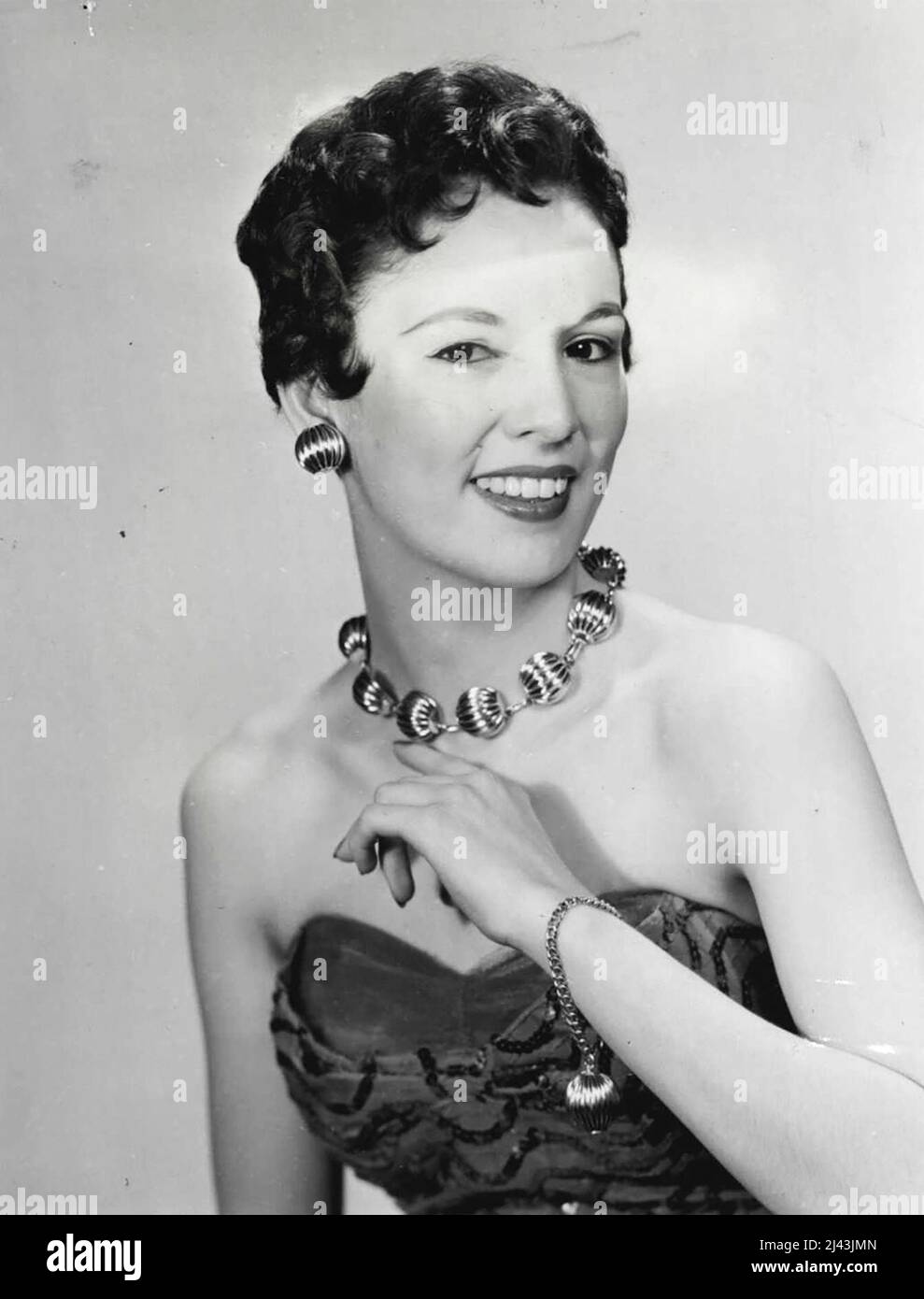 A necklace to match the earrings which hold the receiver set is attractive. September 06, 1954. (Photo by Australian International Press Agency). Stock Photo