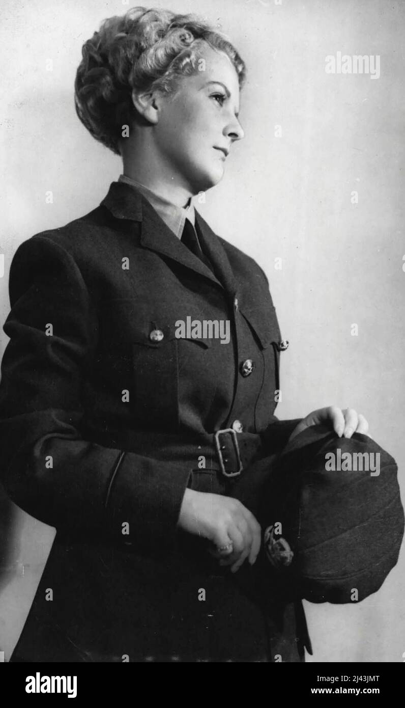 New Coiffures For National Service Girls - A girl in the uniform of the Women's Auxiliary Air Force, with one of the new hair styles. New hair styles are being created for the special benefit of Britain's girls who are in the National Services - The Army, Air Force, Fire Service, etc,. who have to wear tin hats or caps which would ruin an ordinary coiffurt. October 15, 1939. (Photo by Keystone). Stock Photo