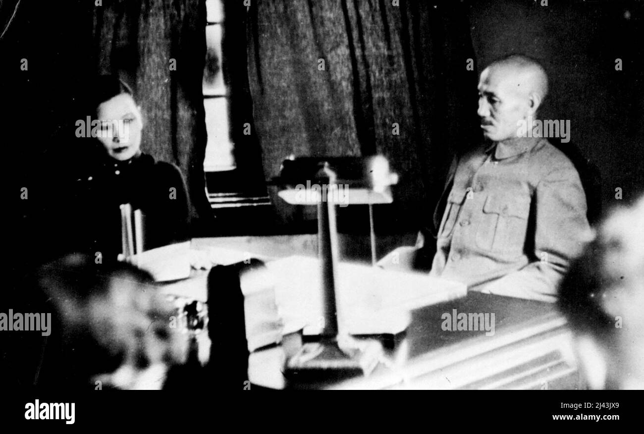 Chinese Generalissimo And Wife Direct War Operations -- General Chiang Kai-Shek, Chinese Generalissimo, and his American-educated wife, Madame Kai-Shek, are here seen at work in the General's office here, the capital of China. Madame Kai-Shek has proved herself a remarkable woman during the days of Crisis. October 18, 1937. (Photo by Associated Press Photo). Stock Photo