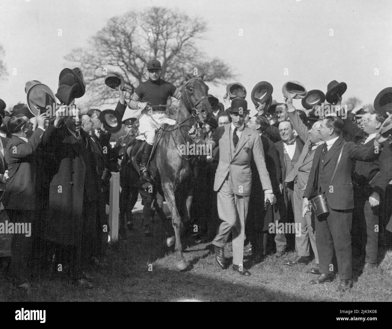 King and Queen see the Prince of Wales win the Welsh guards cup at hawthorn hill Steep Lechase. Cheering the Prince, as he is led in after winning the race. January 1, 1923. (Photo by Central News). Stock Photo