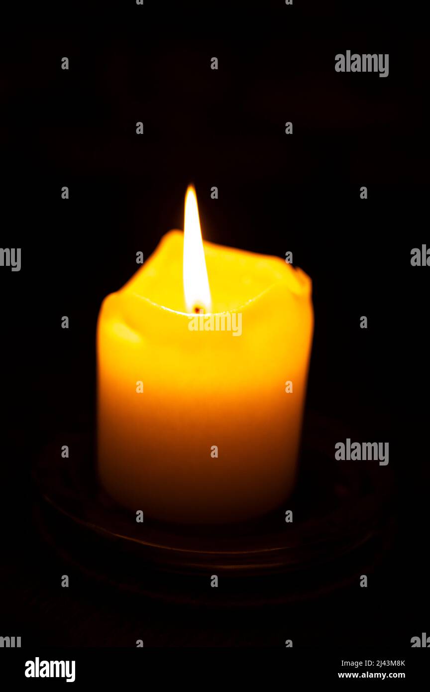 One burning candle in dark underground