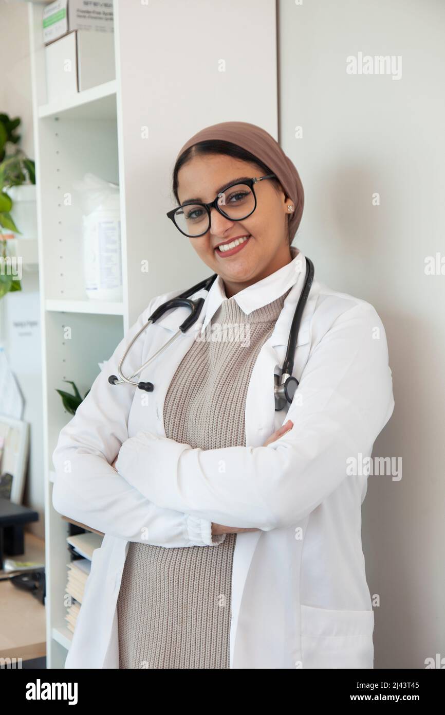 an international medical student or doctor looking smart and smiling in her office Stock Photo