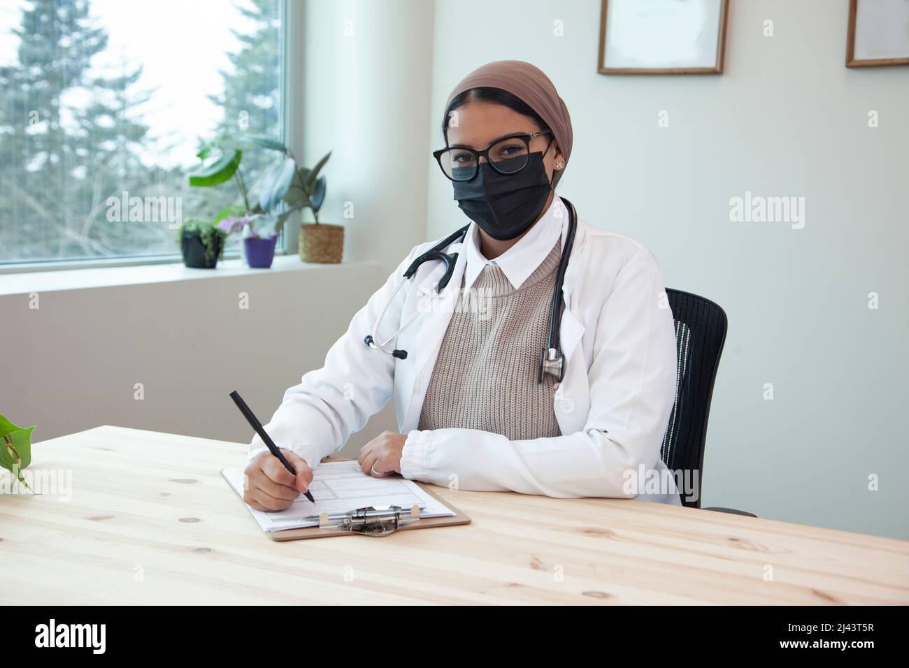 doctor with a hijab stethascope and mask at work in a medical clinic Stock Photo