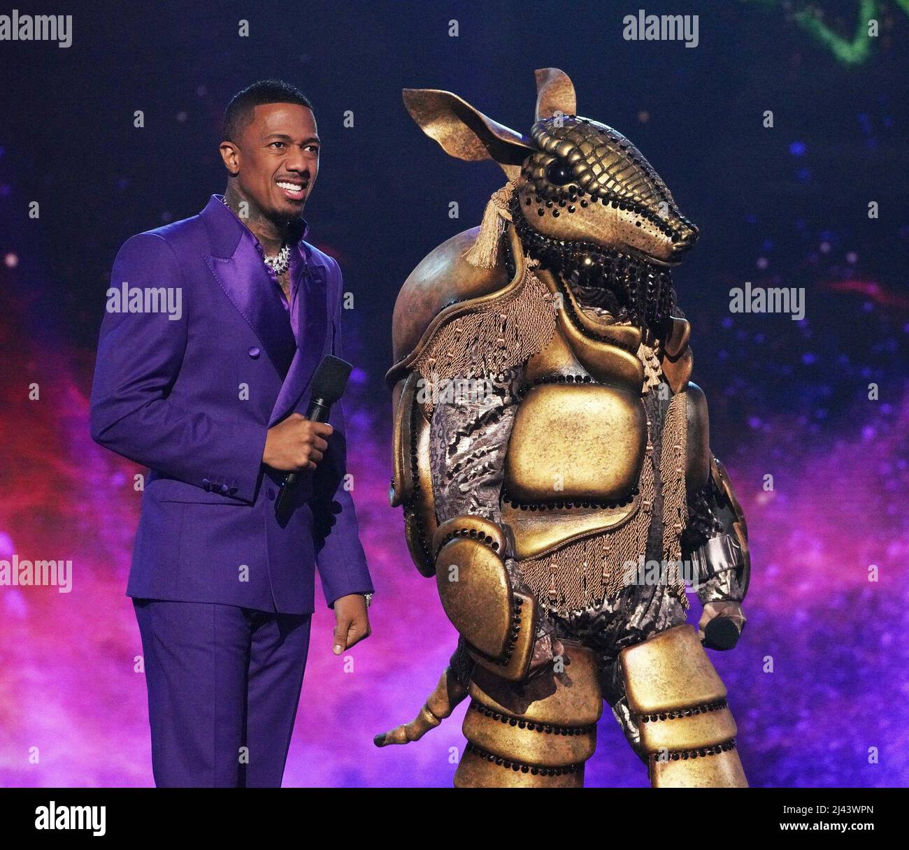 THE MASKED SINGER, from left host Nick Cannon, Armadillo, Masking For
