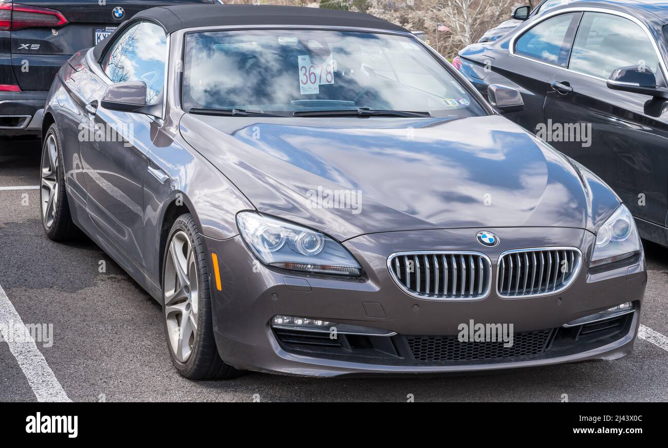 BMW coupe convertible for sale at a dealership with the sky reflecting ...