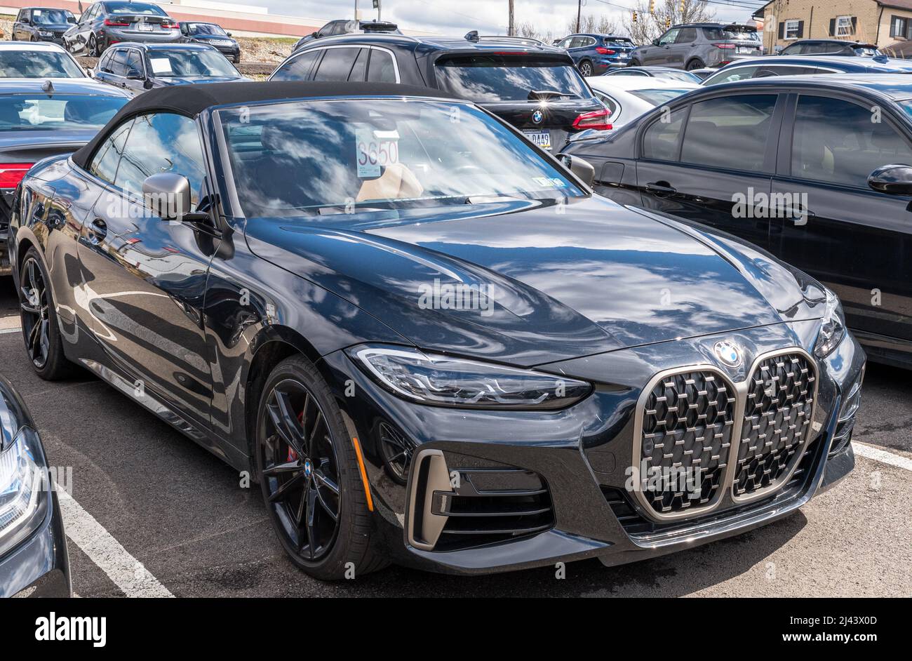 BMW coupe convertible for sale at a dealership with the sky reflecting ...