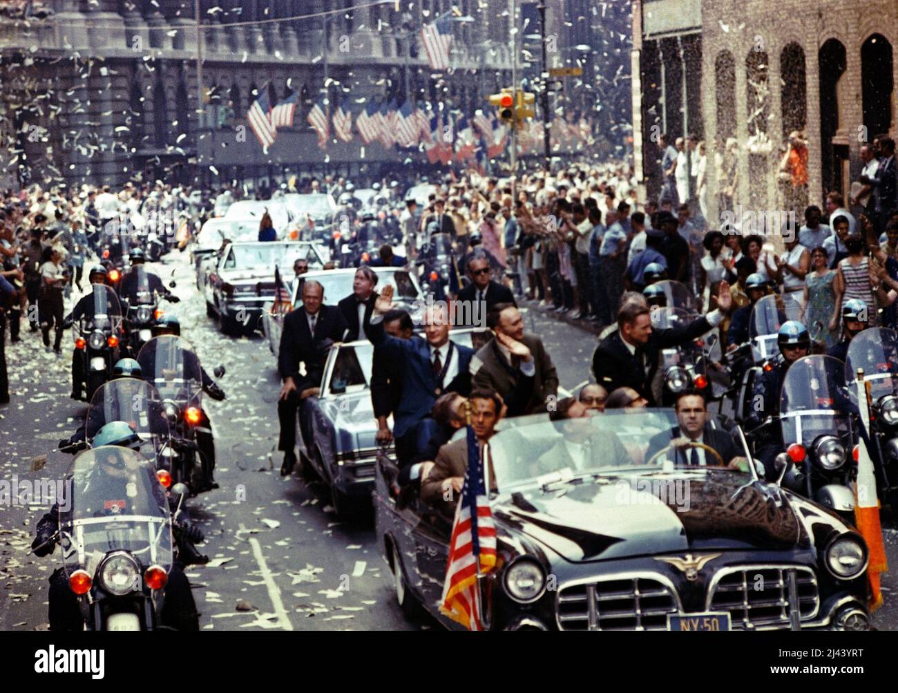 Ticker tape parade for the Apollo 11 astronauts. Location is Manhattan, New York City on the section of Broadway known as the 'Canyon of Heroes'. Pictured in the lead car, from the right, are astronauts Neil Armstrong, Michael Collins and Edwin (Buzz) Aldrin. Stock Photo
