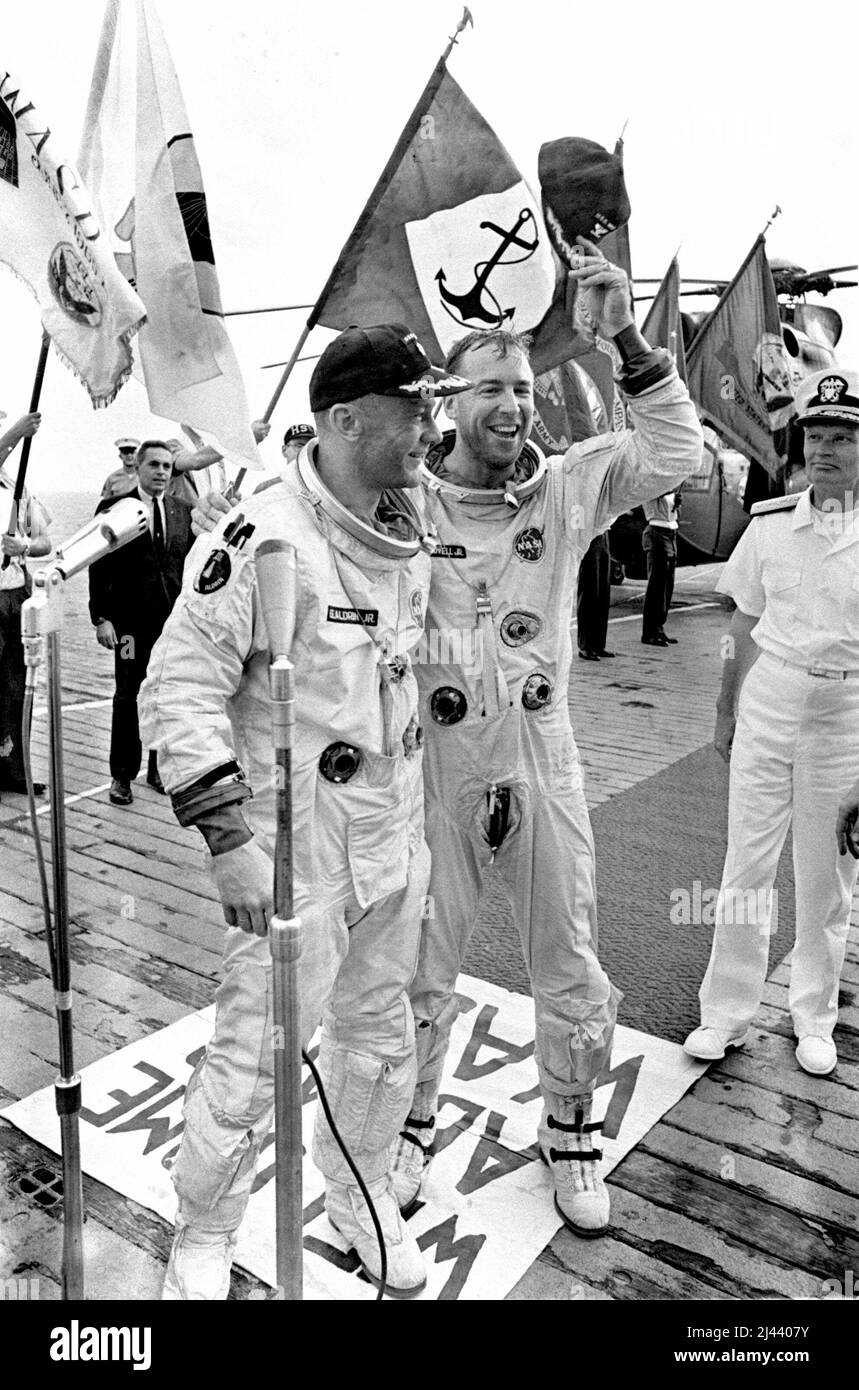 Astronauts James Lovell and Edwin (Buss) Aldrin are welcomed aboard the aircraft carrier U.S.S. Wasp after their Gemini 12 spacecraft splashed down in the Atlantic Ocean. Stock Photo