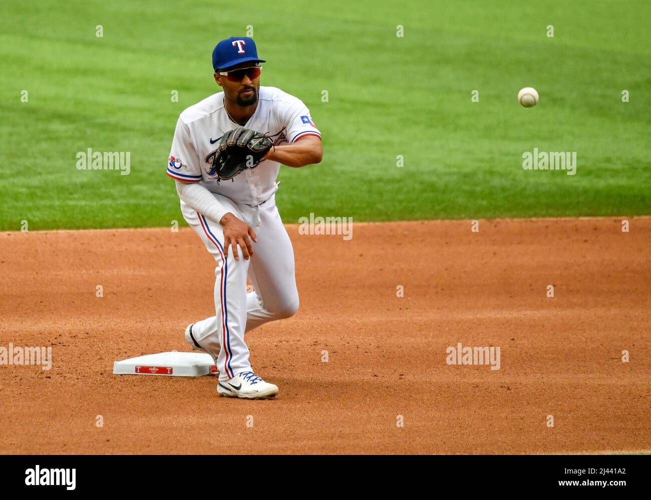 Marcus Semien of the Texas Rangers throws to first base in the