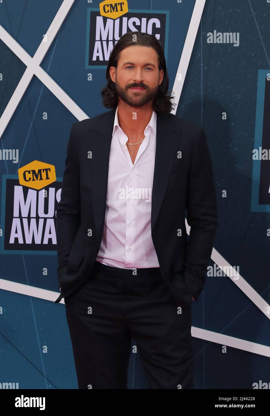 Riley Green is photographed on the red carpet for the CMT Music Awards