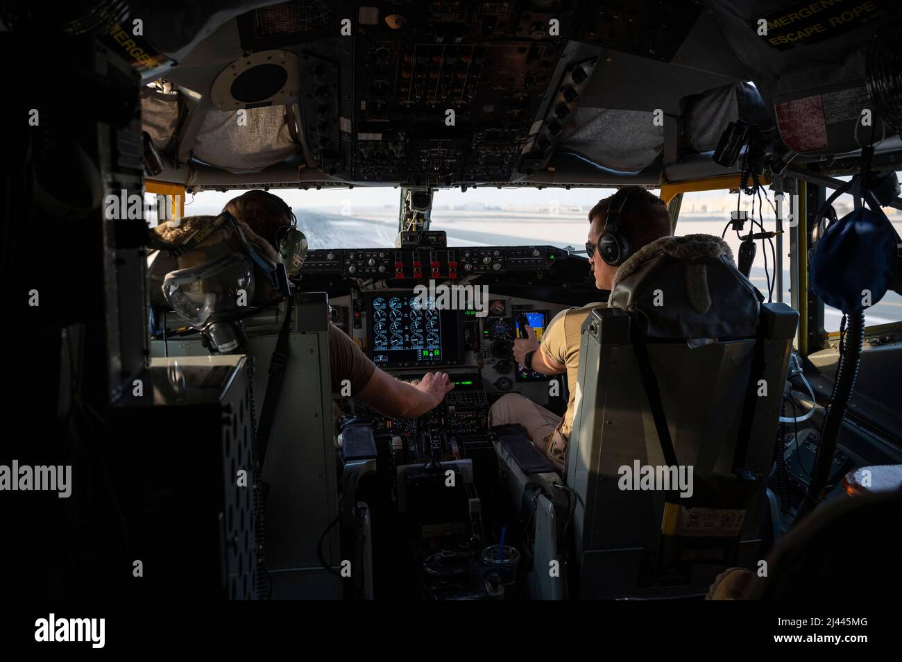 U.S. Air Force Maj. Thomas Evans, left, and 1st Lt. Kyle Blanchette, KC-135 Stratotanker aircraft pilots assigned to 340th Expeditionary Air Refueling Squadron, take off from Al Udeid Air Base, Qatar, April 6, 2022. The 340th EARS deployed with the Ninth Air Force (Air Forces Central), is responsible for delivering fuel to U.S. and partner nation forces, enabling airpower, deterrence, and stability. (U.S. Air Force photo by Tech. Sgt. Christopher Ruano) Stock Photo